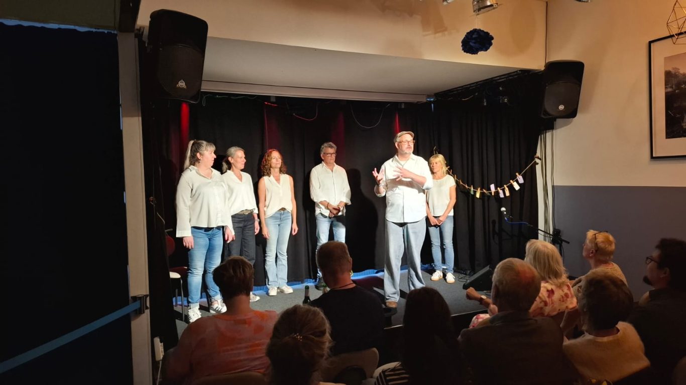 Ensemble Spontanika auf der Bühne Die Gruppe Spontanika steht gemeinsam auf der Bühne im Kultavida und spricht zum Publikum.